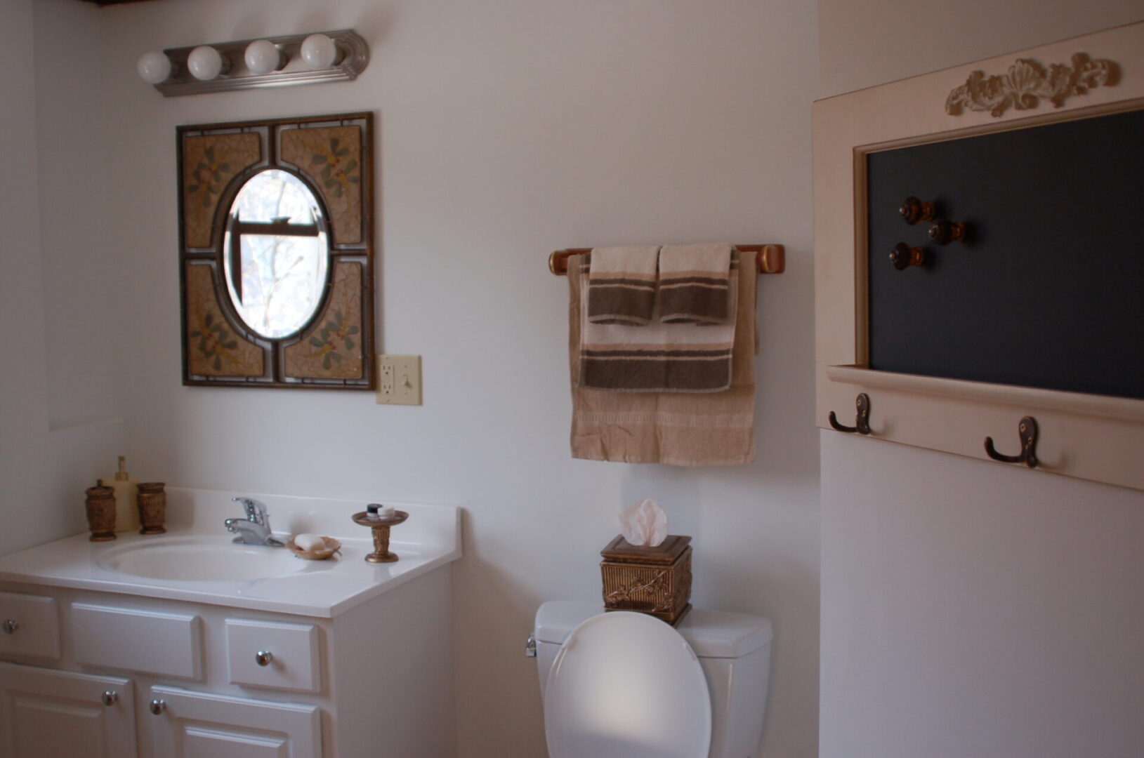 White bathroom with a toilet and sink.