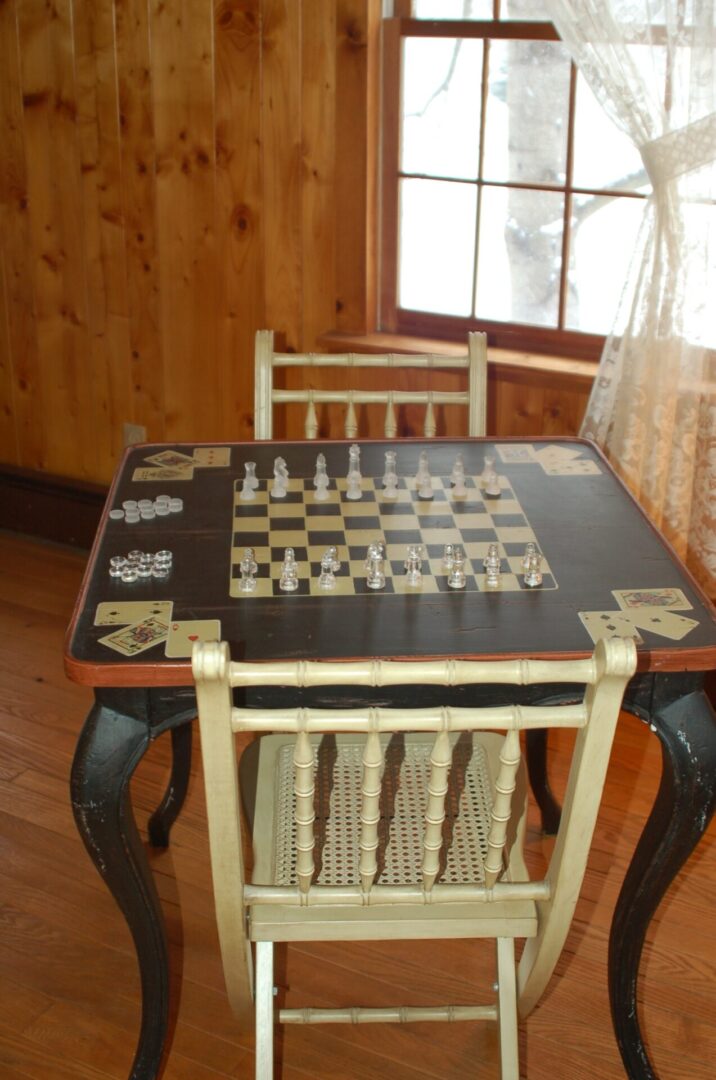 Chessboard game table with chairs.