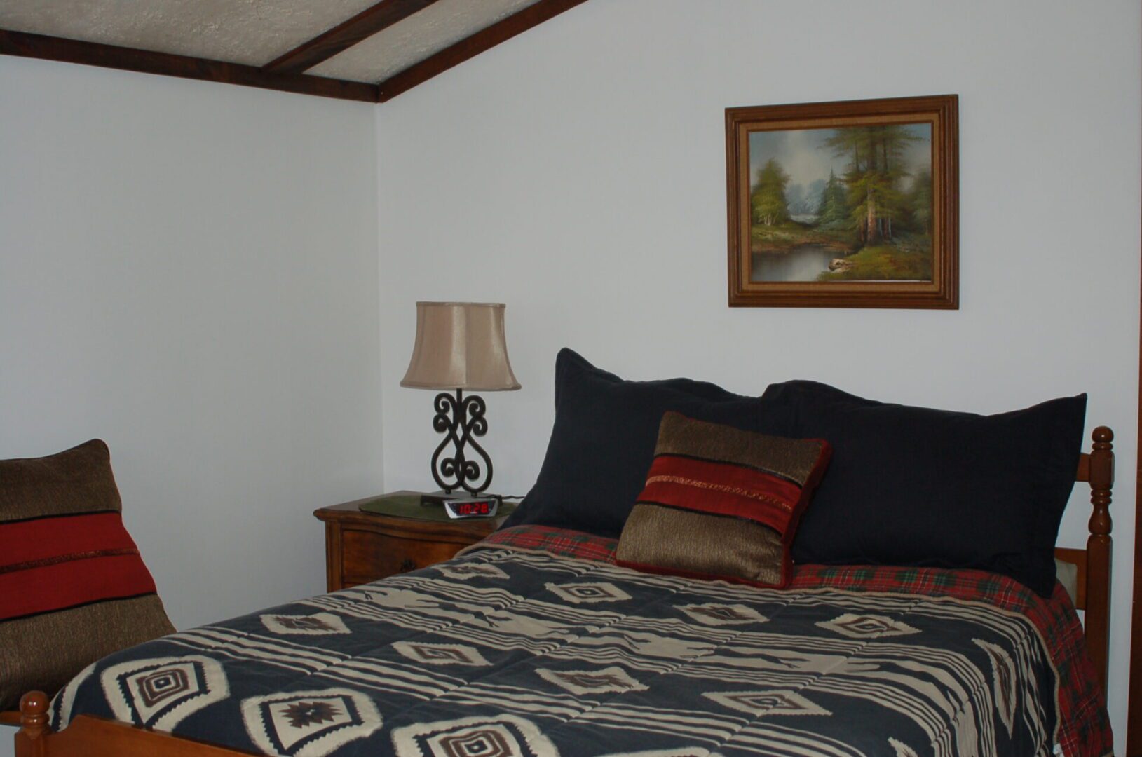 Bed with patterned bedding and pillows.